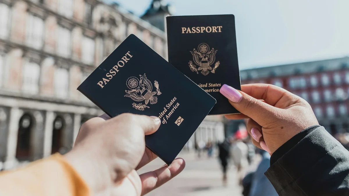 A traveler holding two passports