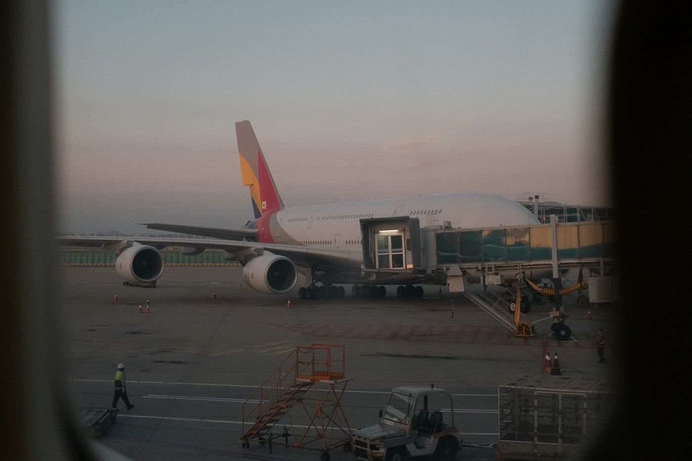 An aircraft at Incheon, viewed through an airplane window; plan refund formalities before boarding.