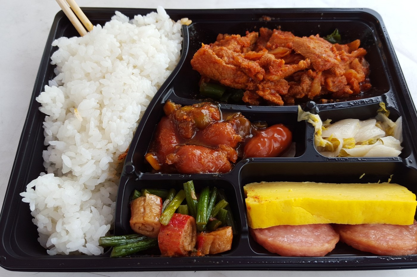 Illustrative Korean rice-and-sides lunchbox; this is not a current product or stock listing.